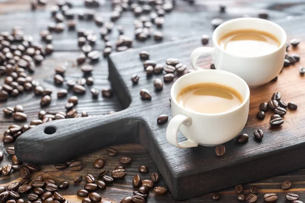 Two cups of coffee with coffee beans — Stock Photo, Image