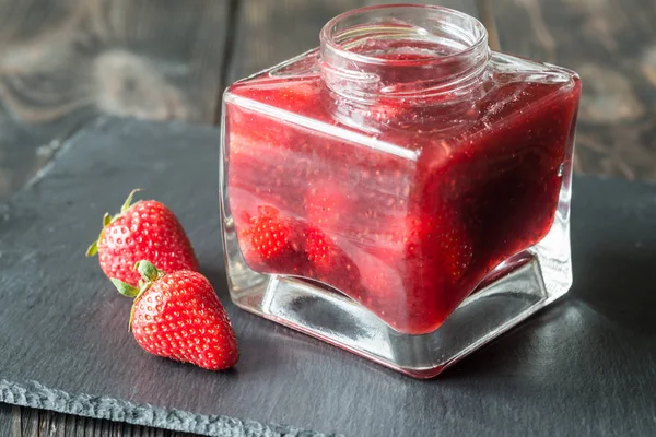 Glass jar of strawberry jam — Stock Photo, Image