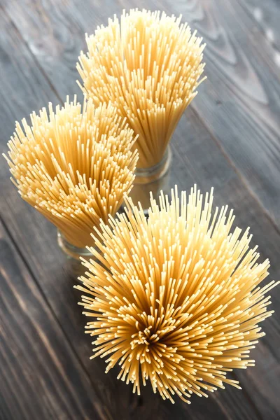 Uncooked spaghetti in the glass — Stock Photo, Image