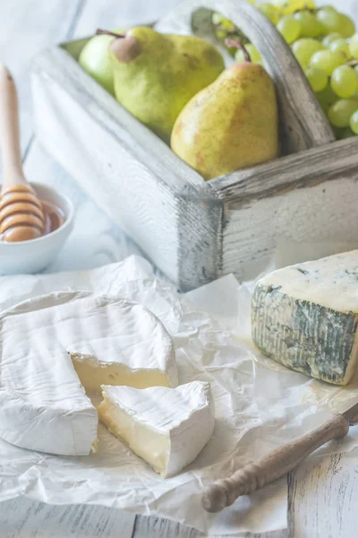 Camembert och roquefort med päron och druvor — Stockfoto