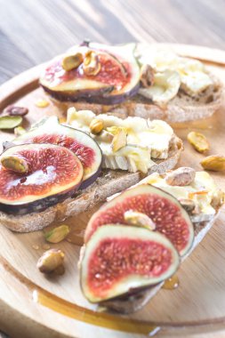 Camembert, incir ve antep fıstığı ile ekmek dilimleri