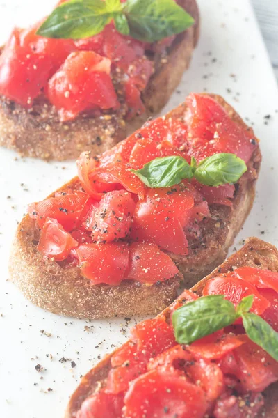 Bruschetta with cherry tomatoes and basil — Stock Photo, Image