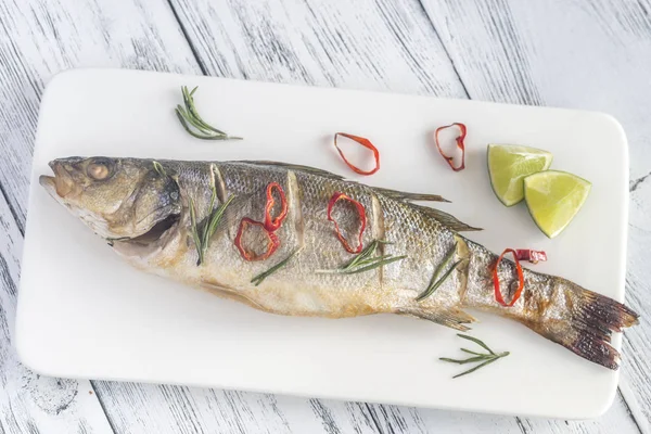 Baked sea bass with lime and chilli pepper — Stock Photo, Image