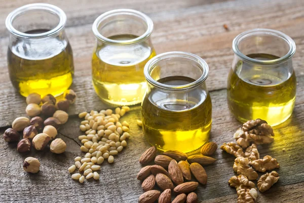 Glass jars with different kinds of nut oil — Stock Photo, Image