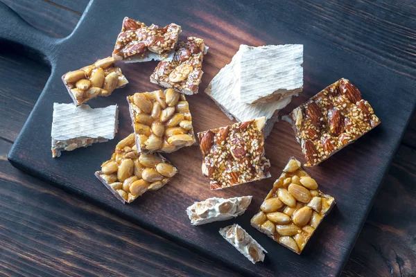 Slices of turron on the wooden board — Stock Photo, Image