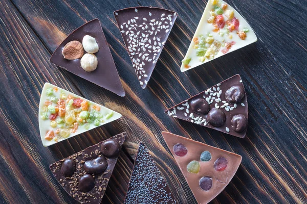 Chocolate candies with different toppings — Stock Photo, Image