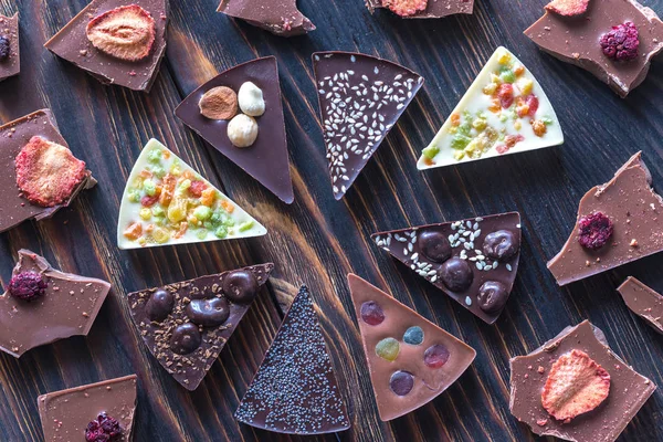 Chocolate candies with different toppings — Stock Photo, Image