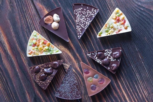 Chocolate candies with different toppings — Stock Photo, Image