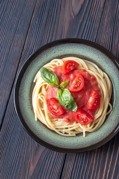 Pasta con salsa de tomate y albahaca fresca en el plato — Foto de Stock