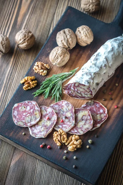 Salami de nuez en la tabla de madera — Foto de Stock