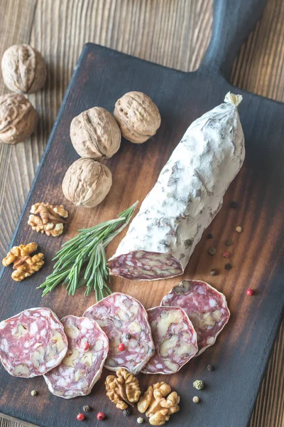 Salami de nuez en la tabla de madera — Foto de Stock