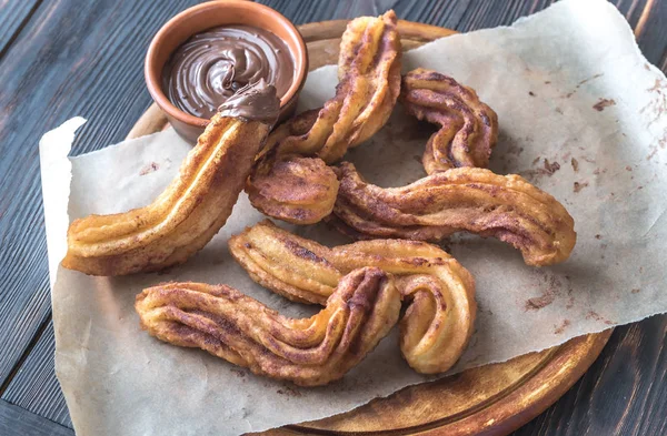 Churros with chocolate sauce — Stock Photo, Image