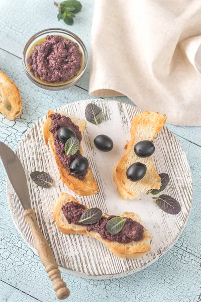 Toasts with black olive pate — Stock Photo, Image