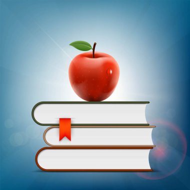 Kırmızı elma bir yığın kitap üzerinde yalan.