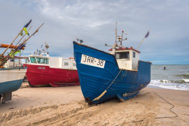 Jaroslawiec, Poland - October 31, 2016: Fishing boats on the beach of the Baltic Sea. Jaroslawiec, Poland clipart