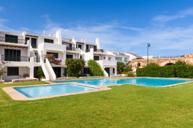 Minorca, Spain - October 12, 2019: Summer villas with swimming pool in the beautiful town of Fornells on Menorca