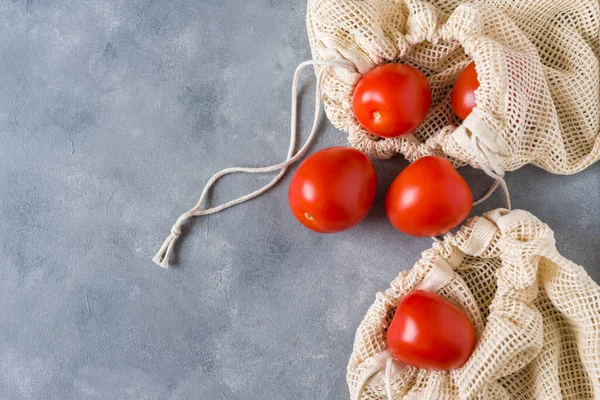 Tomatoes in a cotton eco shopping bag. No waste concept