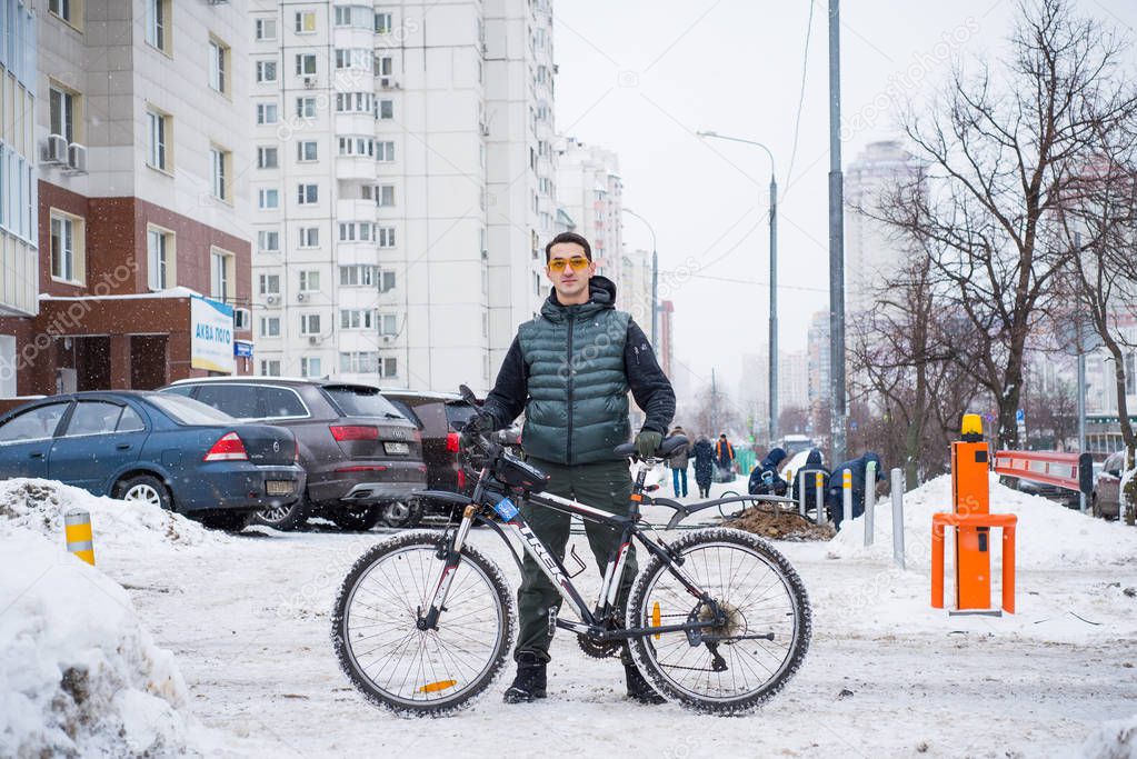  man on a bicycle in the winter in the city 