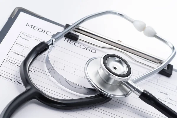 Stethoscope and medical record on white background. — Stock Photo, Image