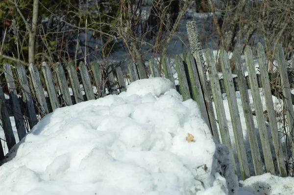 fence damaged with snowdrift