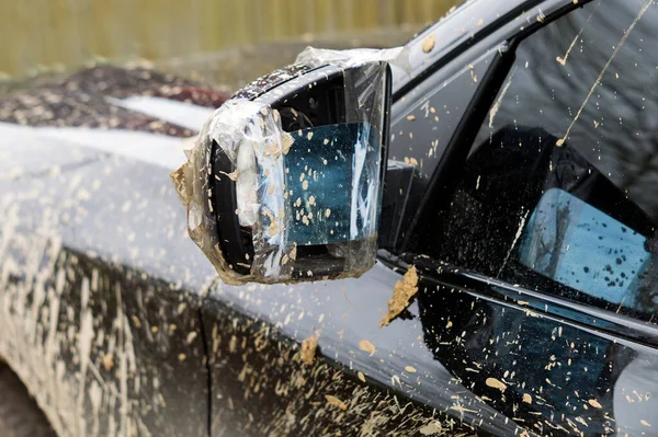 Broken mirror of a dirty vehicle, outdoor close-up shot