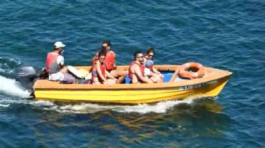 People Riding In Motorboat