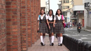 Kaldırımda yürüyen kız öğrenci