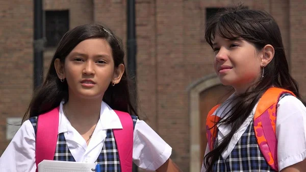Hispanic Young Female Students Wearing School Uniforms