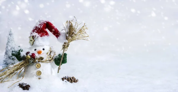 Happy snowman standing in winter with copyspace