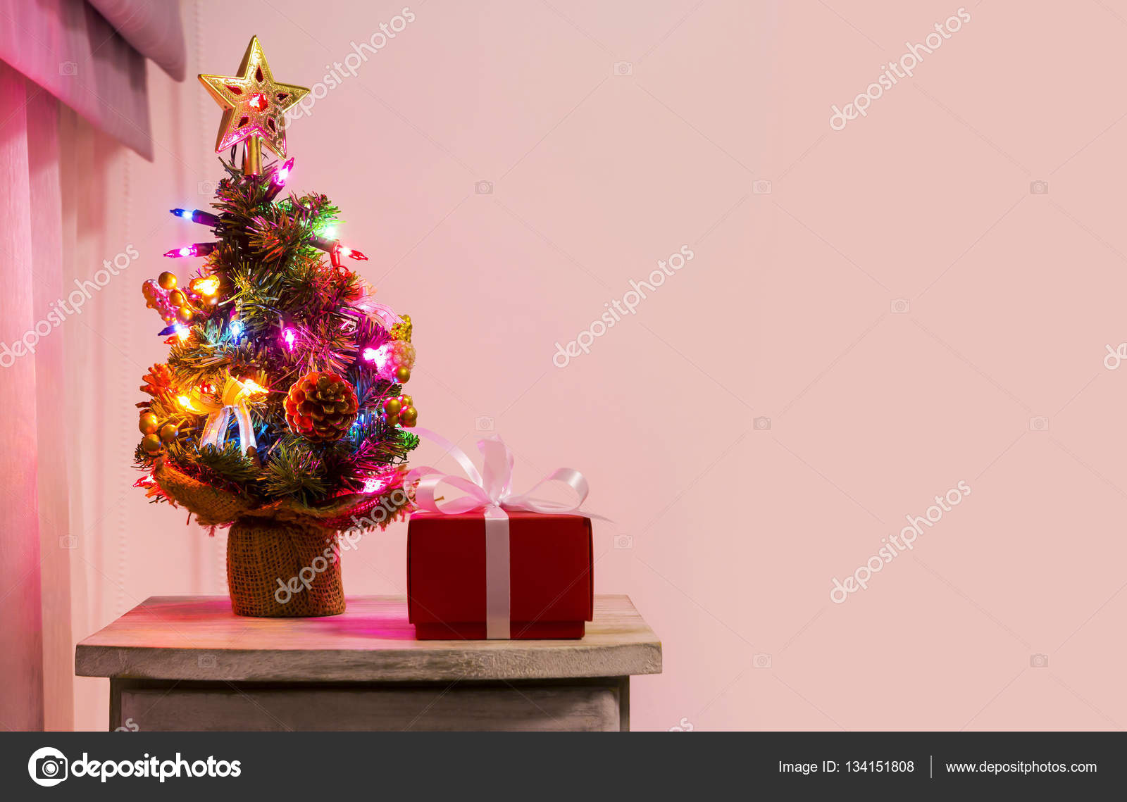 Colorful Small Christmas Tree On Cabinet In The Bedroom