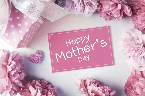 Happy mothers day message on pink paper and carnation flowers and gift box — Stock Photo, Image