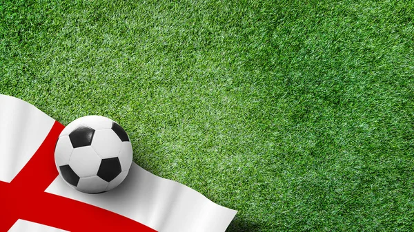 Soccer ball with England flag on green grass in stadium with copy space