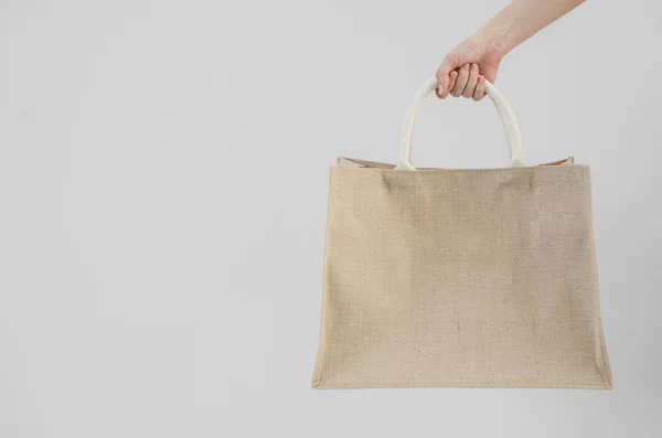 Woman hand holding sackcloth shopping bag with copy space No plastic bag concept — Stock Photo, Image