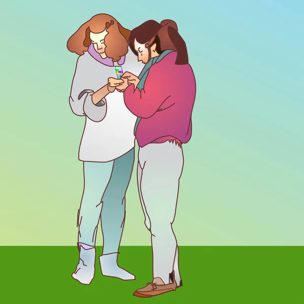 İki kız bir cep telefonuna bakıyor.