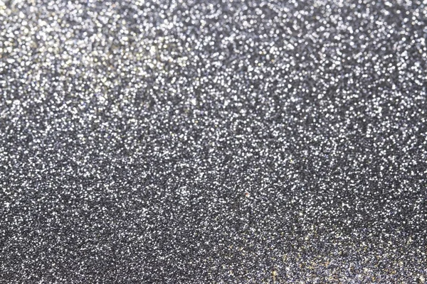 Abstract silver glitter background with shining light and soft bokeh, festive colors — Stock Photo, Image