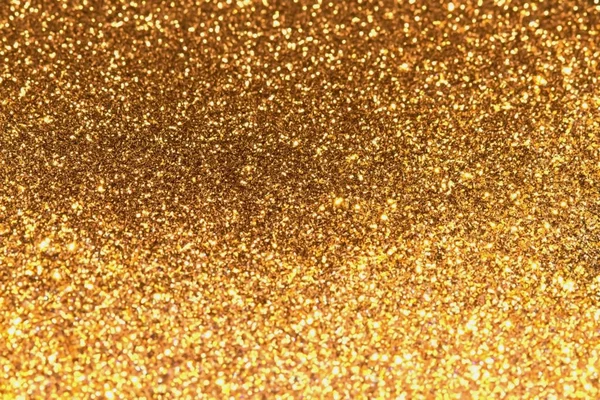 Abstrakt goldener Glitzerhintergrund mit leuchtendem Licht und weichem Bokeh, festliche Farben — Stockfoto