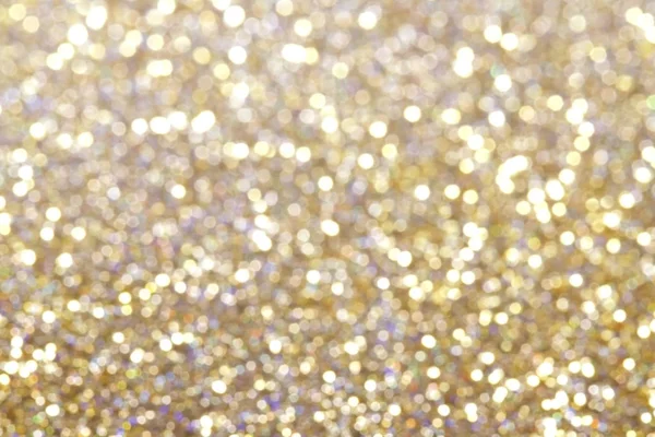Abstrakt goldfarbener Glitzerhintergrund mit leuchtendem Licht und weichem Bokeh, festliche Farben — Stockfoto