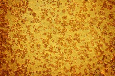 Grunge dokulu taş yüzeyi altın rengine boyanmış. Altın grunge yüzey arka plan