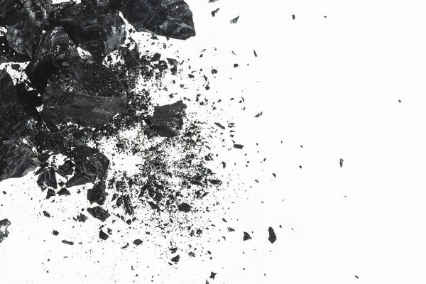 Pile of black coal bars isolated on white background