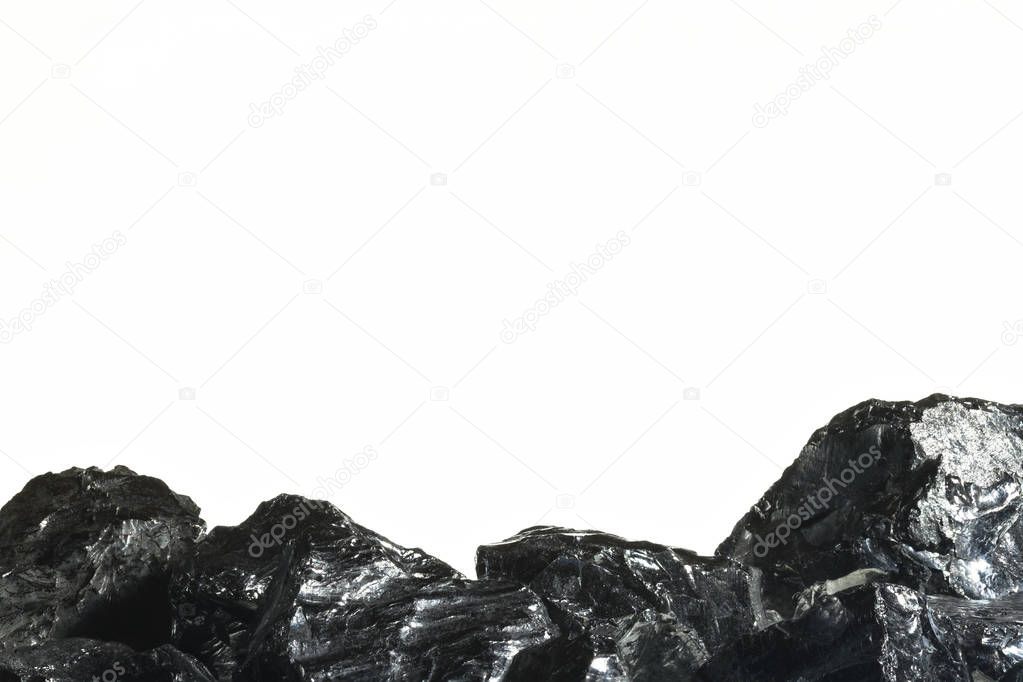 Black coal mine close-up with large depth of field. Anthracite coal bar isolated on white background