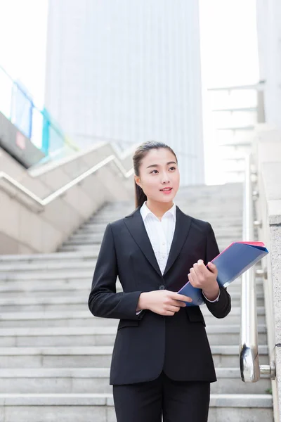 Young Female Secretary Wearing Black Suit Holding Folder — Stock Photo, Image
