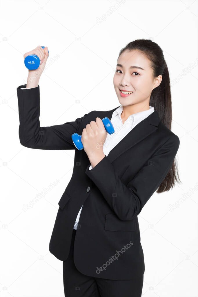 pretty chinese girl holding a dumbbell in motion