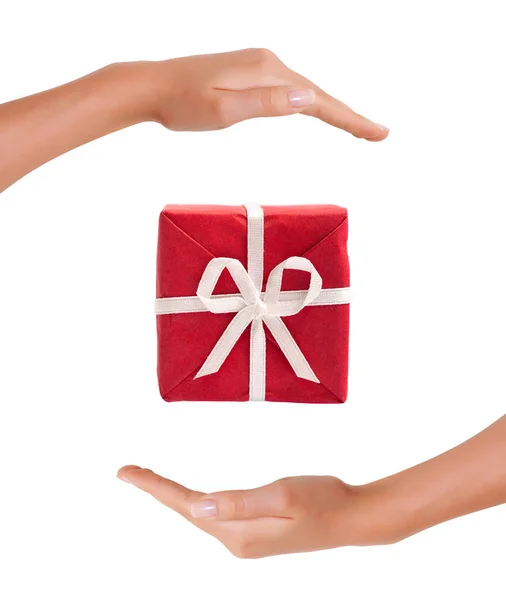 Red Gift Box between hands on white background — Stock Photo, Image