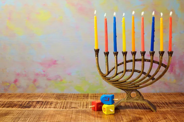 Menorah with candles and dreidel — Stockfoto