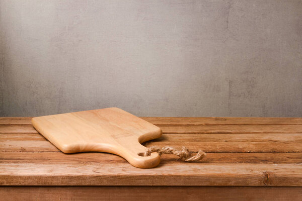 Cutting board on wooden deck table 