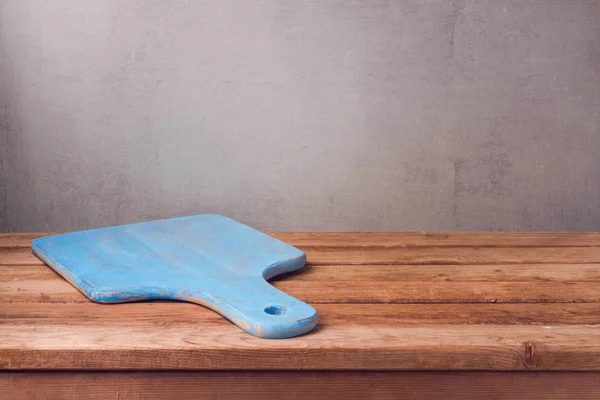 Cutting board on wooden deck table — Stock Photo, Image