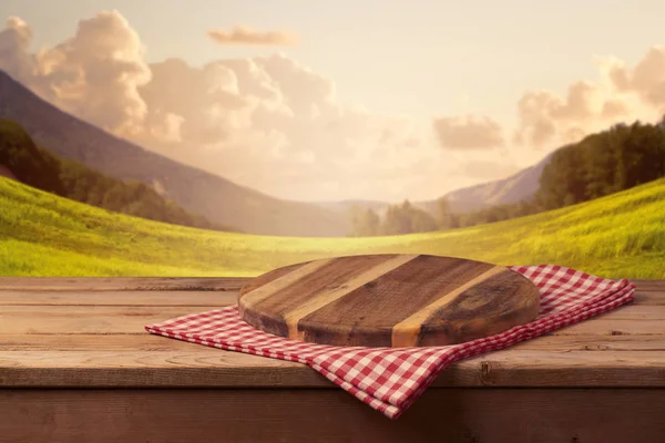 Cutting board with checked tablecloth — Stock Photo, Image