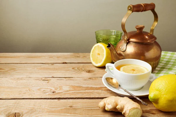 Tea cup, teapot, lemons and ginger — Stock Photo, Image