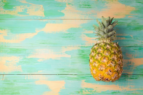 Pineapple over wooden background — Stock Photo, Image