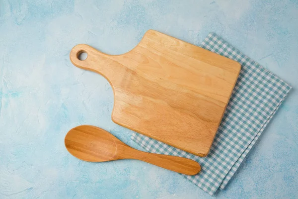 Cutting board, tablecloth and spoon — Stock Photo, Image